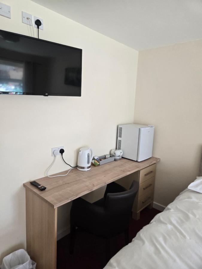 Room desk with TV, kettle and mini fridge at The Granby Rooms