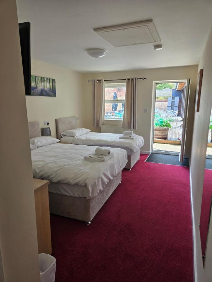 Bedroom with two comfortable double beds at The Granby Rooms